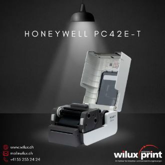 Honeywell PC42E-T Desktop-Etikettendrucker mit geöffnetem Gehäuse zeigt einfaches Medienhandling, Druckkopf und Etikettenrolle für Thermotransfer- und Thermodirektdruck