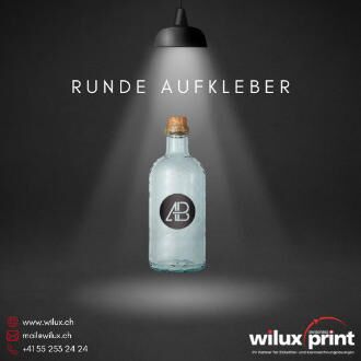 Eine Glasflasche mit einem runden, schwarzen Aufkleber auf der Vorderseite, der ein minimalistisches Logo zeigt.