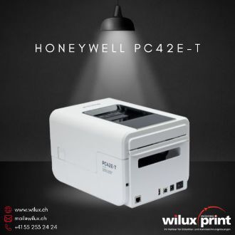 Honeywell PC42E-T Desktop-Etikettendrucker in Weiss, seitliche Rückansicht zeigt Anschlüsse für USB, Ethernet, Stromanschluss und optionale Erweiterungen wie WLAN und Bluetooth