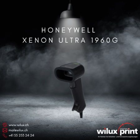 Kabelgebundener Barcode Scanner Honeywell Xenon Ultra 1960G, abgebildet unter einer beleuchteten Lampe vor einem dunklen, nebligen Hintergrund. Ideal für den Einsatz in anspruchsvollen industriellen Umgebungen.