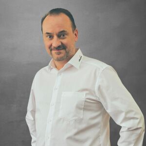 Franz Passenheim, Technischer Verkäufer für Maschinen und Systeme bei WILUX PRINT, professionell gekleidet in einem weissen Hemd, vor einem neutralen Hintergrund.