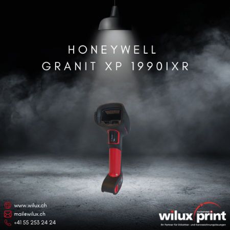 Kabelgebundener Barcode Scanner Honeywell Granit XP 1990iXR, abgebildet unter einer beleuchteten Lampe vor einem dunklen Hintergrund. Ideal für industrielle Anwendungen in extremen Umgebungen.