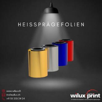 Rollen mit Heissprägefolien in Gold, Silber, Blau und Rot, ideal für hochwertige Oberflächenveredelung in verschiedenen Branchen.